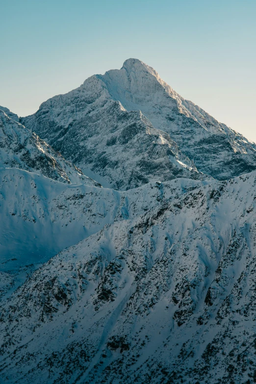 the view of some mountains that are covered in snow