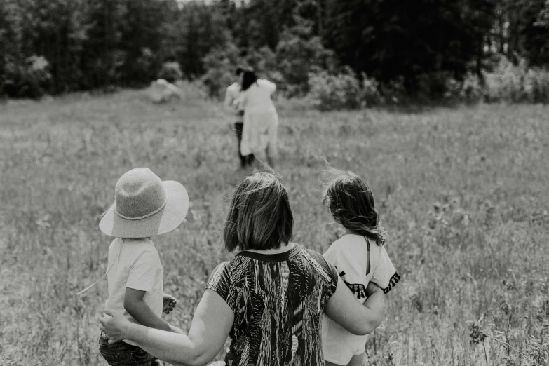 a group of people walking through a field