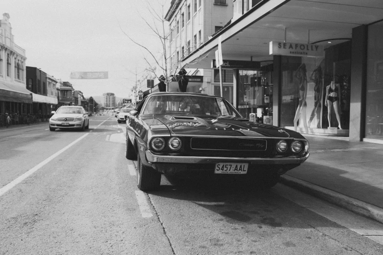 black and white pograph of cars on the road