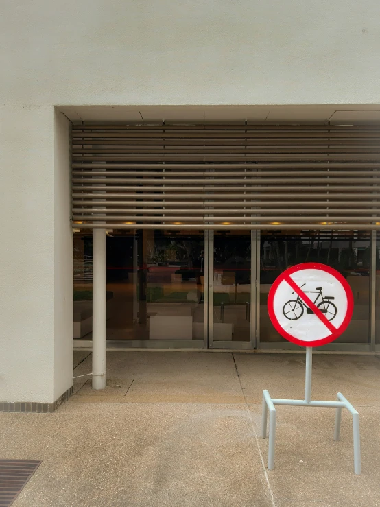 a red and white sign in front of a building