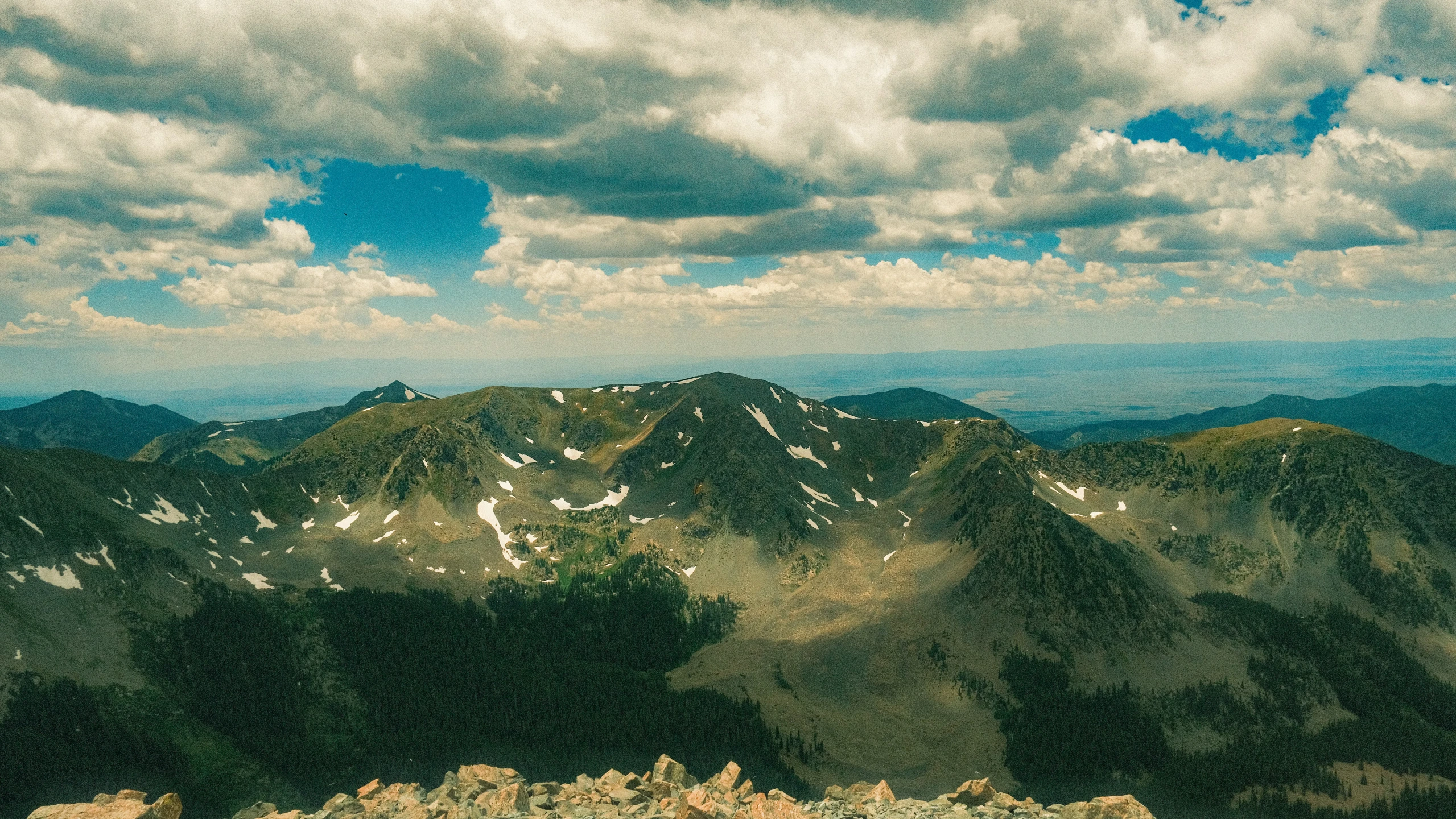 a cloudy sky on a mountain range