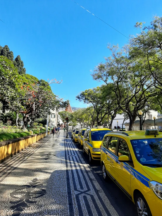 a street with yellow taxis parked on each side