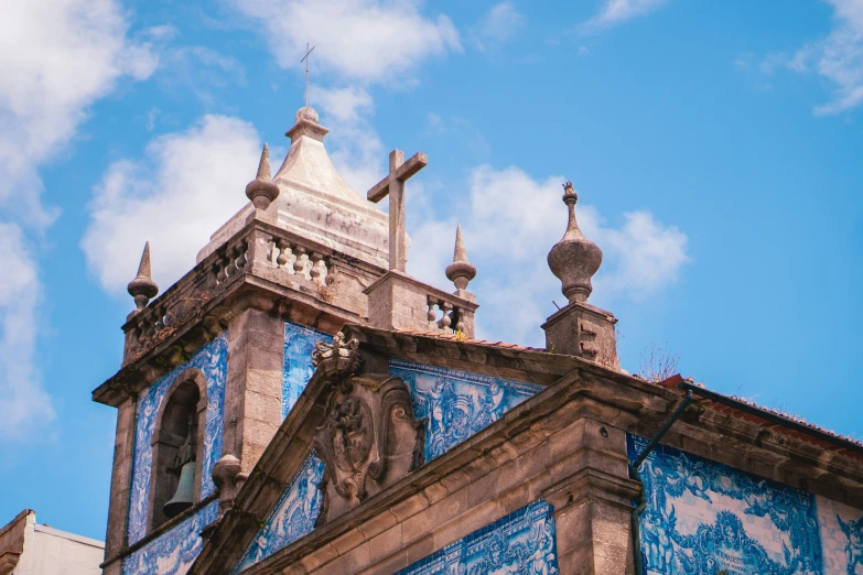 ornate roof top with painted blue tiles and cross spires