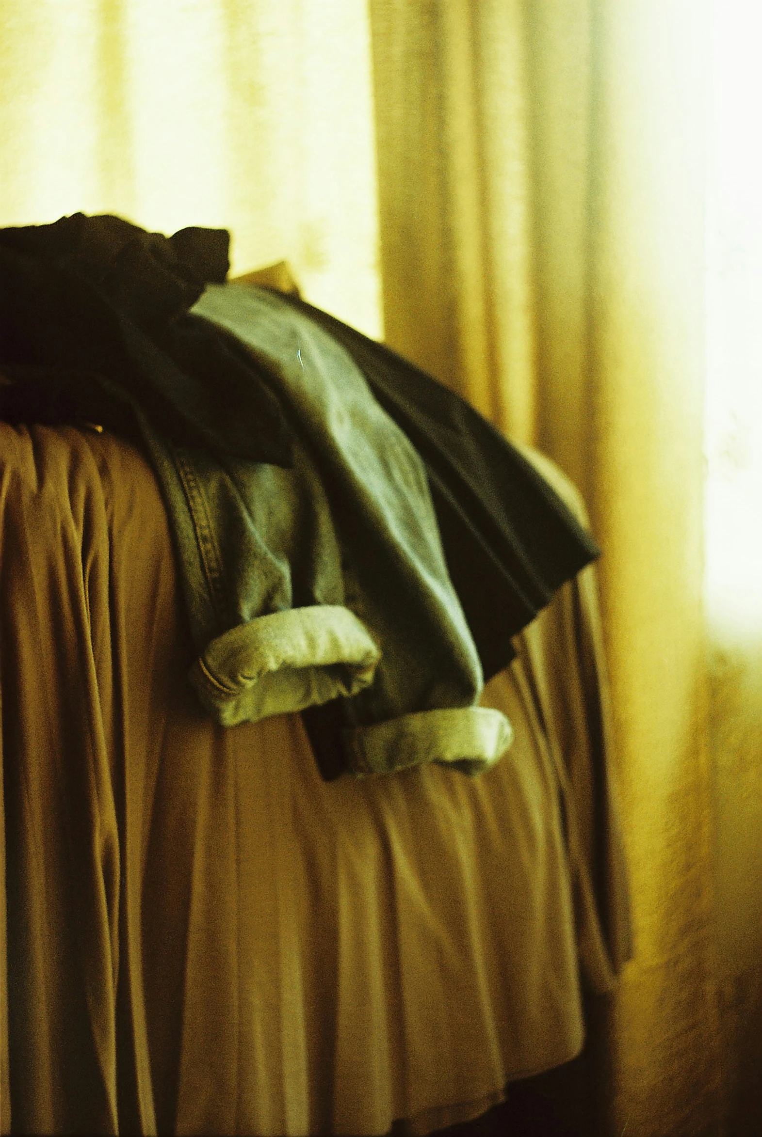 a black jacket is sitting on a wooden bed