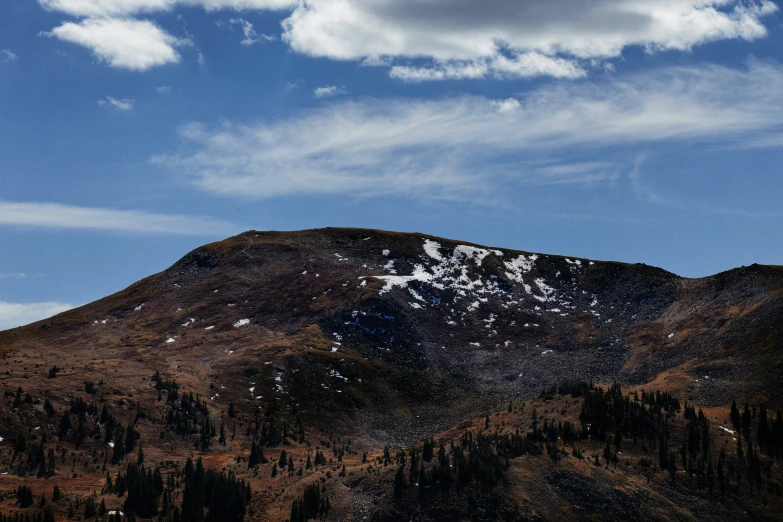 a mountain is shown with trees below it