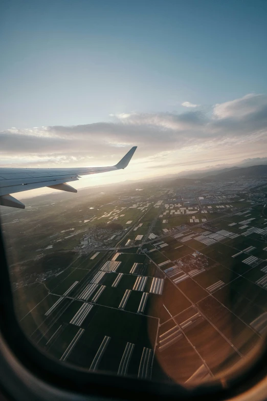 a view out an airplane window of the wing and tail section