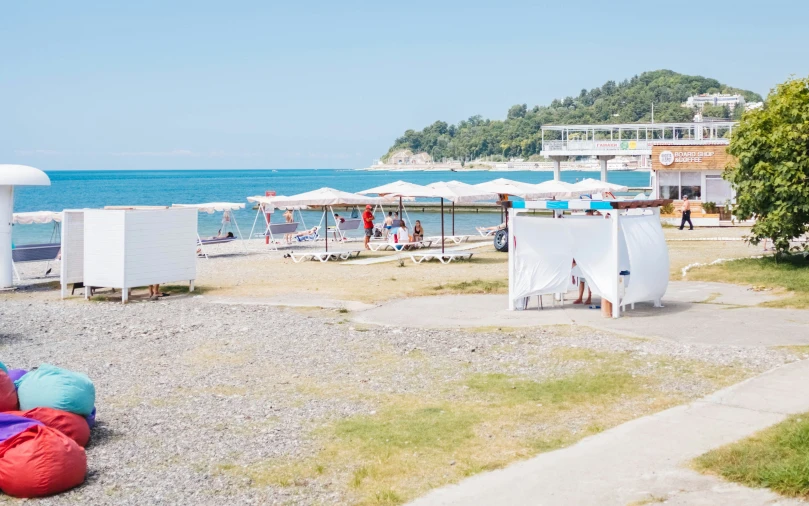 two tents are on the side of a body of water