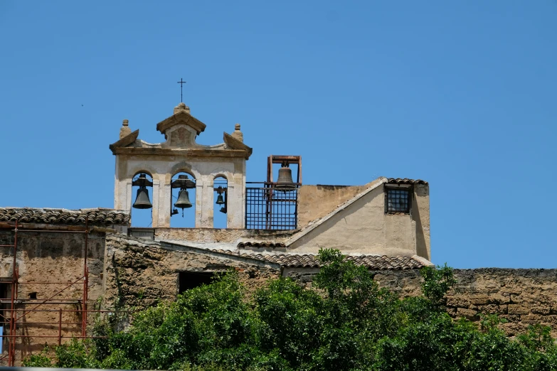 the top of an old building with a clock on it