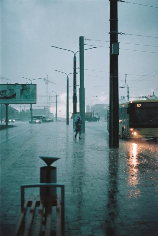 a train driving down the road in a heavy rain