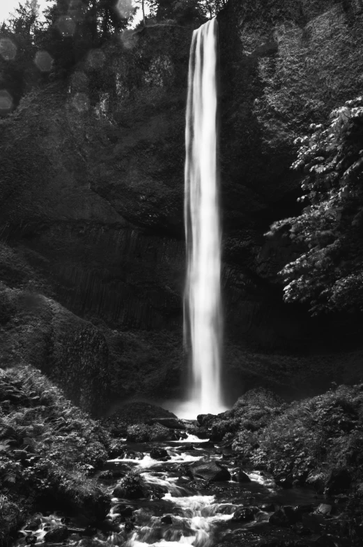 a black and white image of a waterfall