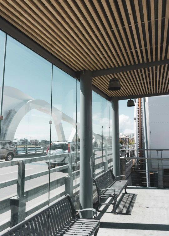 an empty bench at the terminal is next to the windows