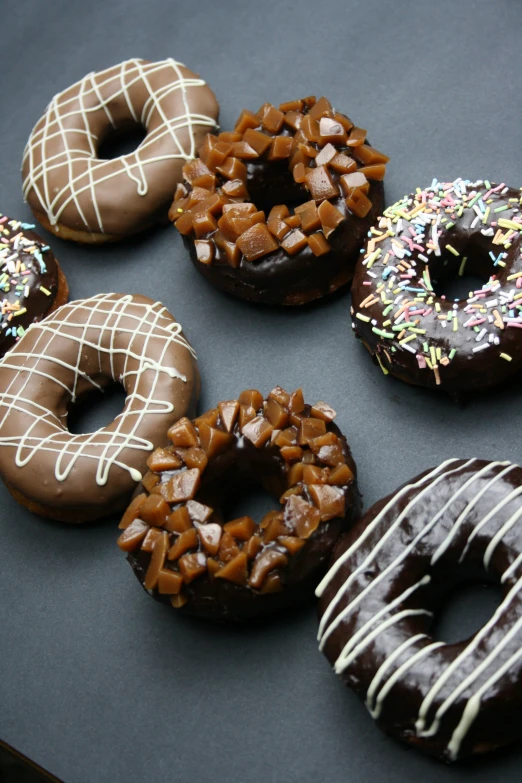 a bunch of doughnuts that have different types of toppings