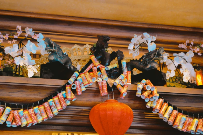 a display of paper lanterns and hanging decorations on a mantel