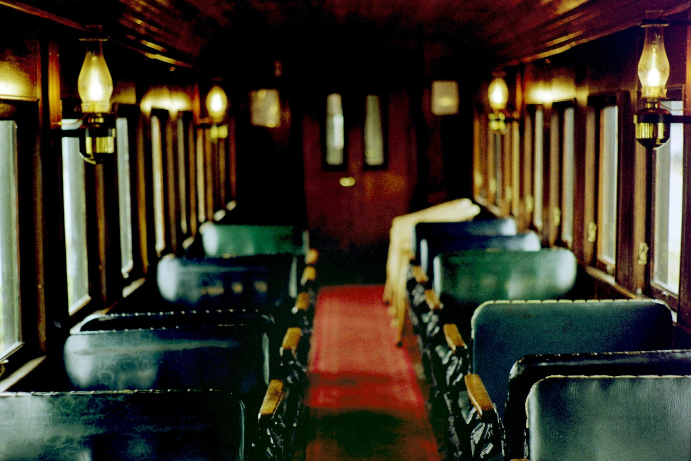 interior of a train with wood paneling and leather seats