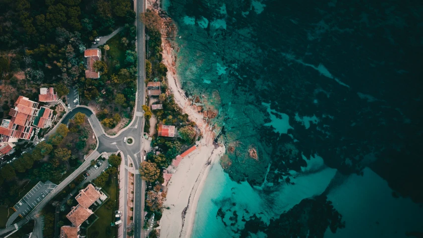 an aerial view of a highway and a sandy beach