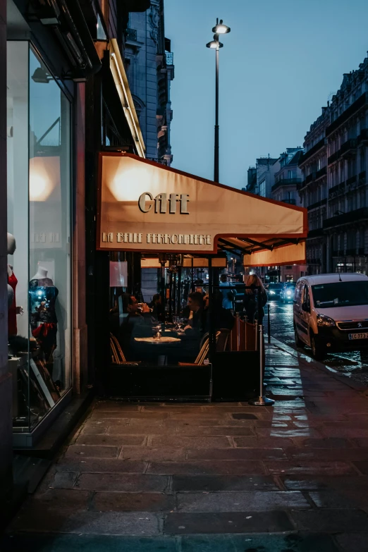 a street with parked cars in front of a restaurant