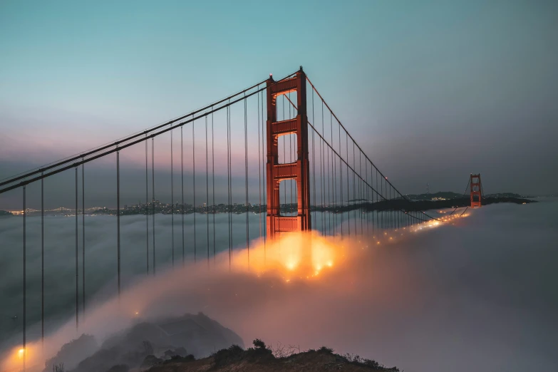 the golden gate bridge in san francisco during a foggy night