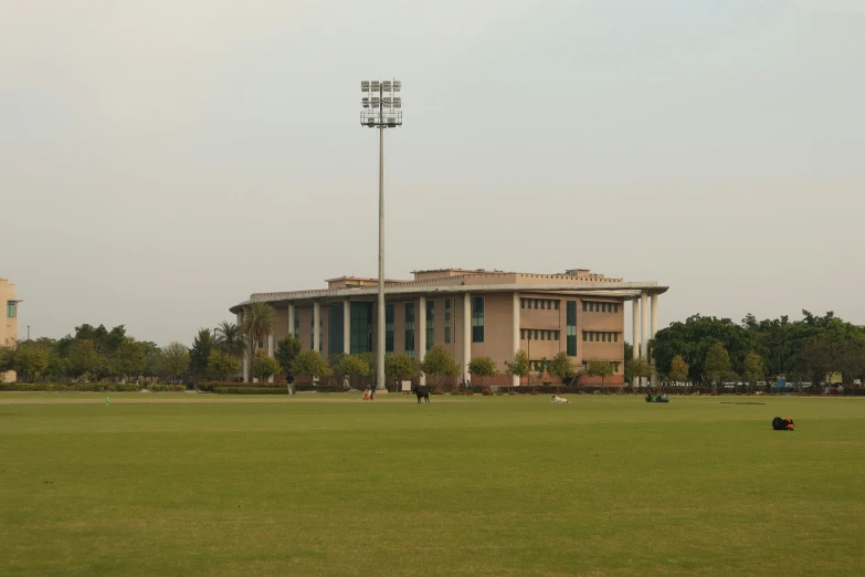 a large soccer field with a sports stadium in the background
