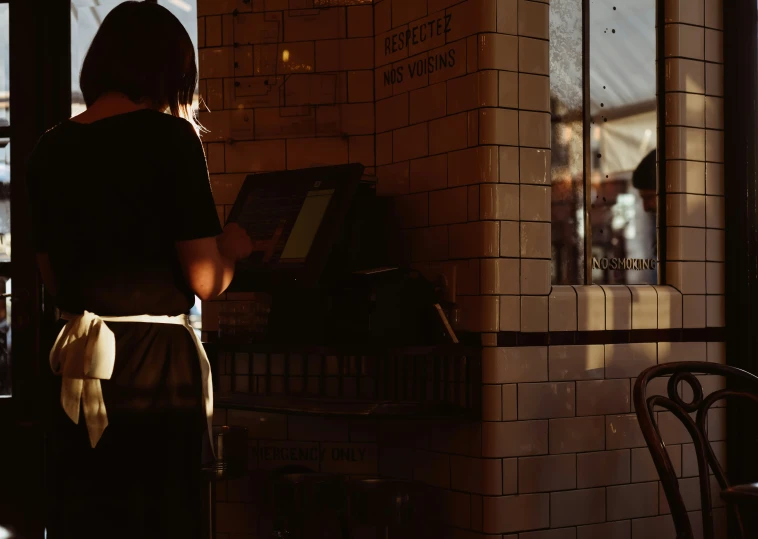 there is a woman looking at a music equipment on display