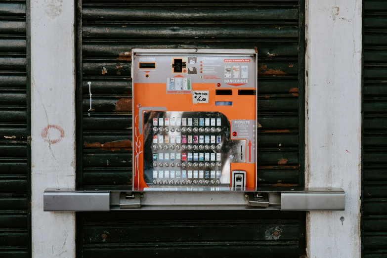 the orange machine sits on top of the metal stand