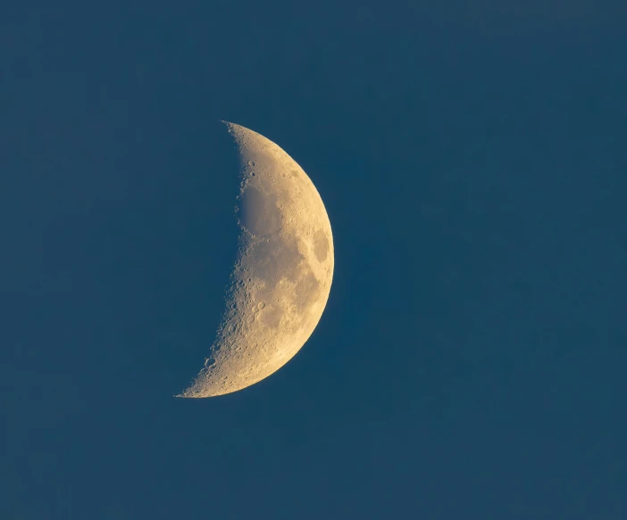 a half moon with a blue sky background