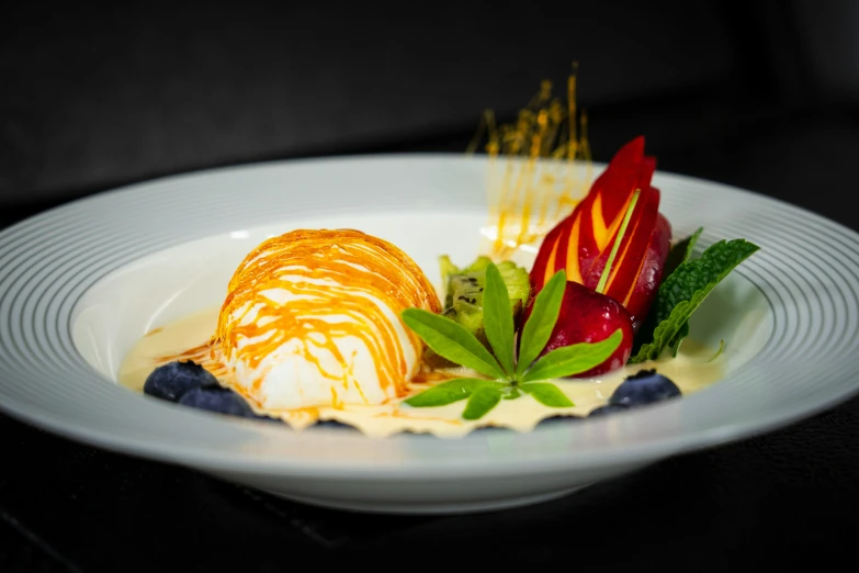 small dish with cream, fruit, and greens garnished