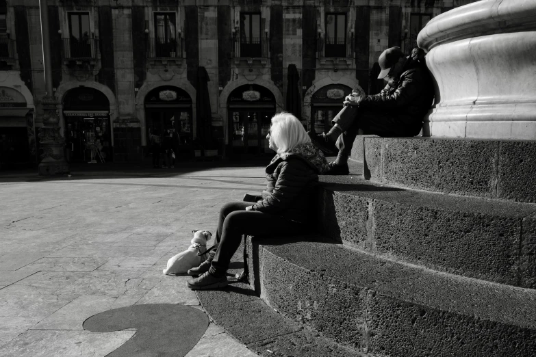 a couple of people sitting next to each other on a bench