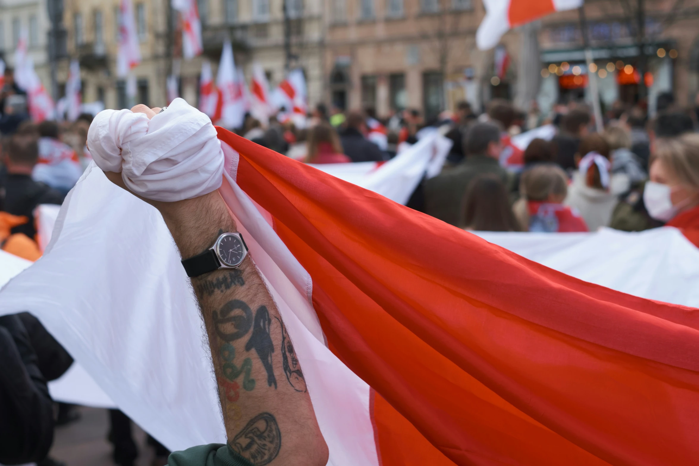 a person with a red and white flag in his hand