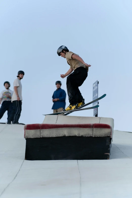 a man that is on a rail with his snowboard