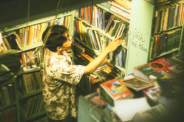 a person picking up soing from a shelf