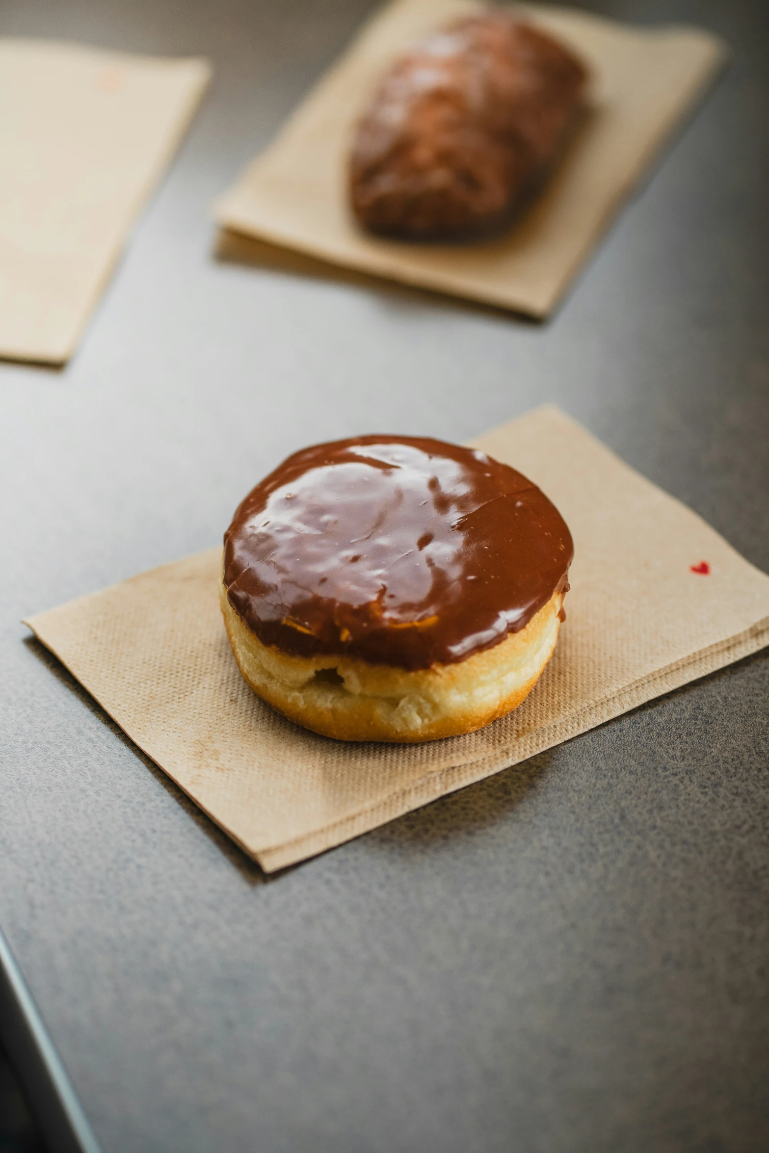 some food on napkins and another one is chocolate donut