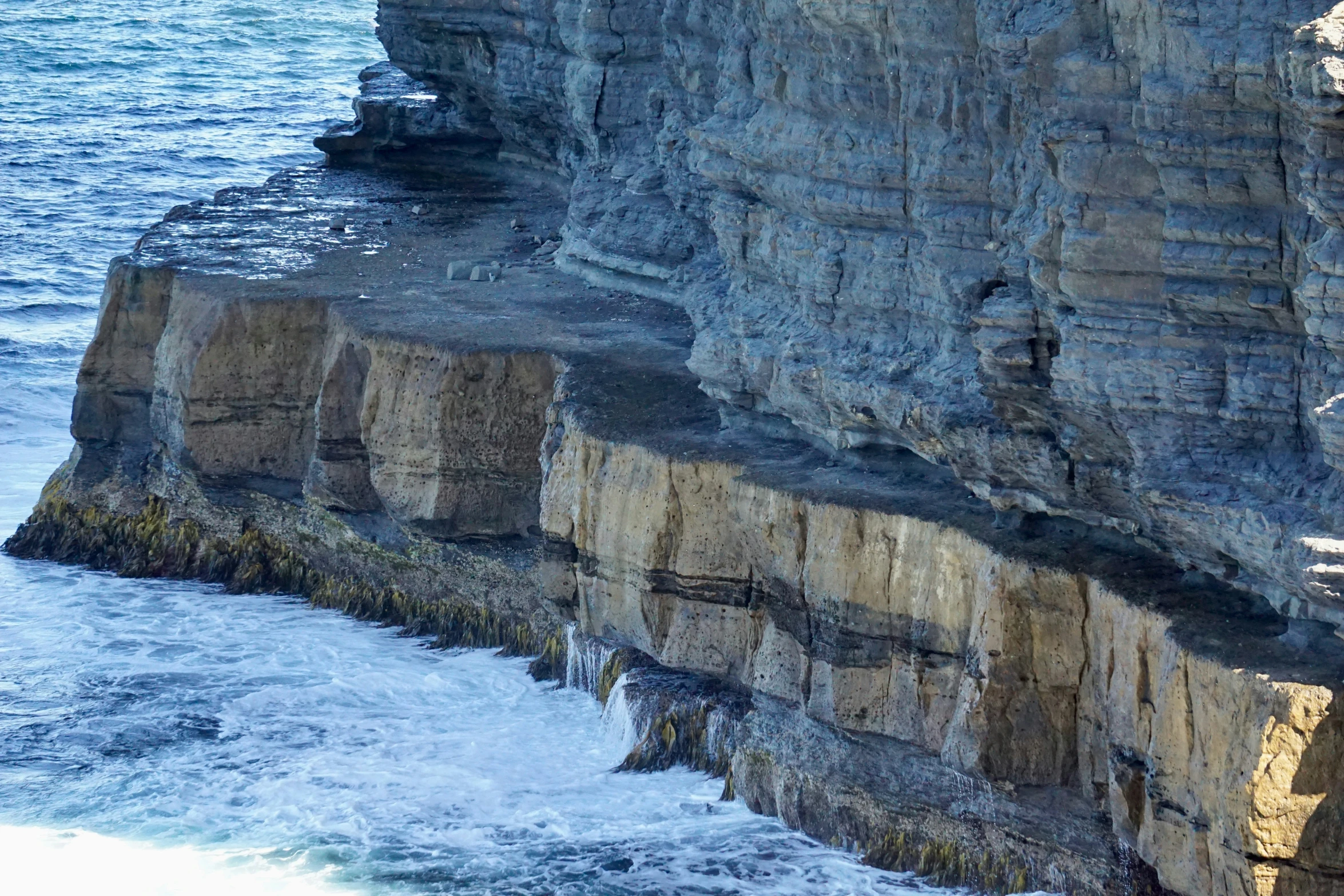 cliff of a cliff with sea in the background