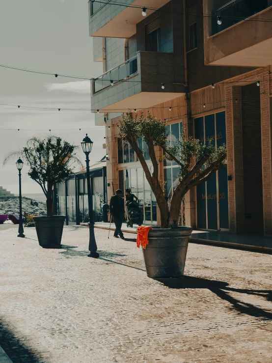 a sandy area in front of a tall building