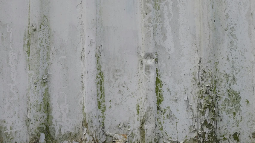 a yellow fire hydrant sitting on the side of a wall