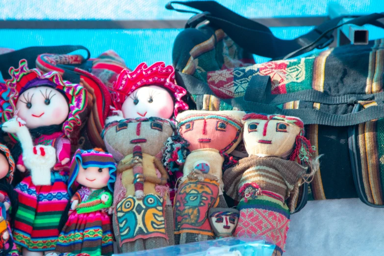 three colorful dolls, each with different colors and size