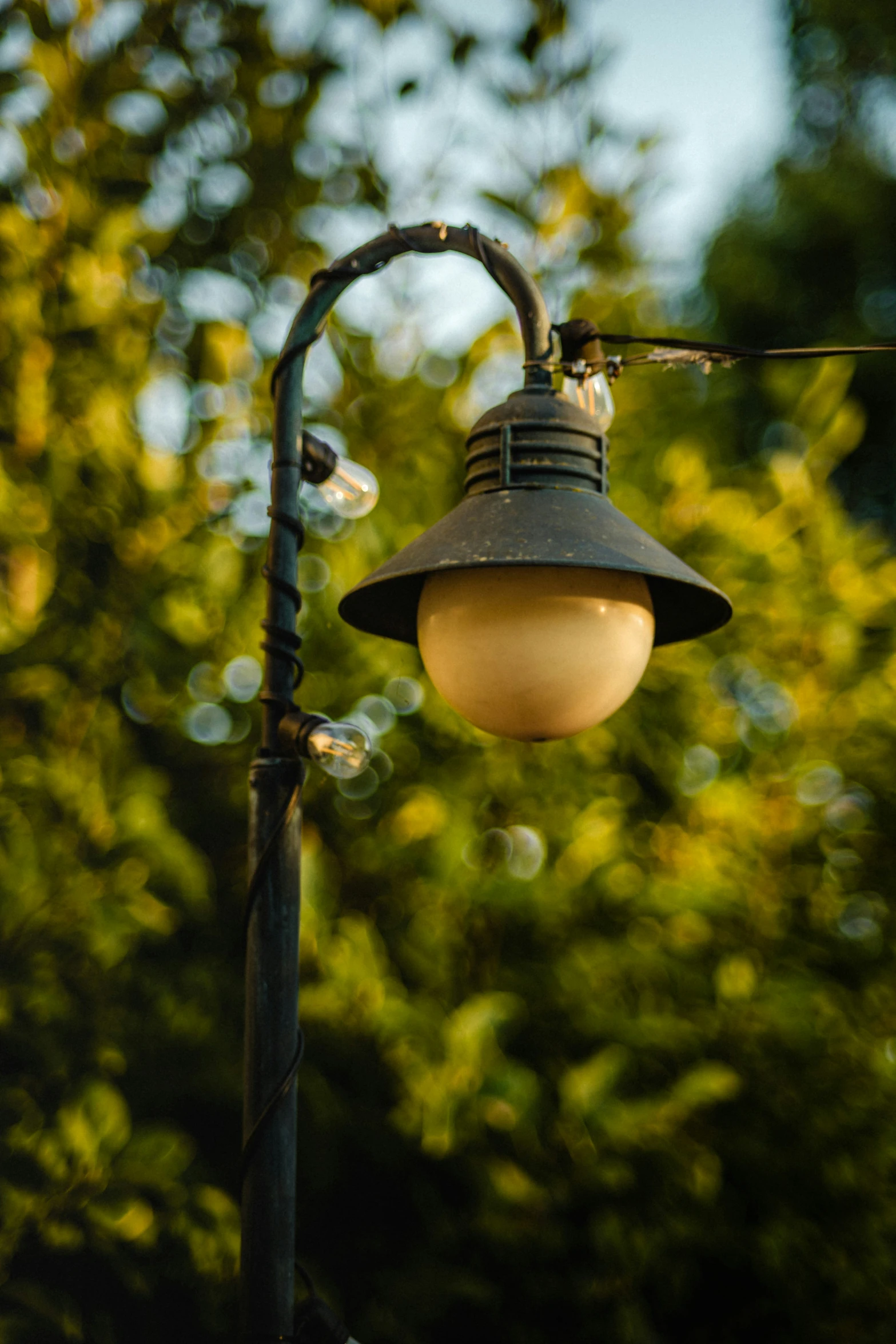 a street lamp is lit with an old fashioned light