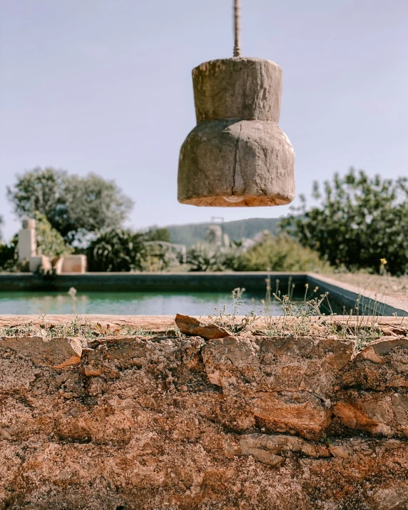 a stone lamp is shown next to a pool