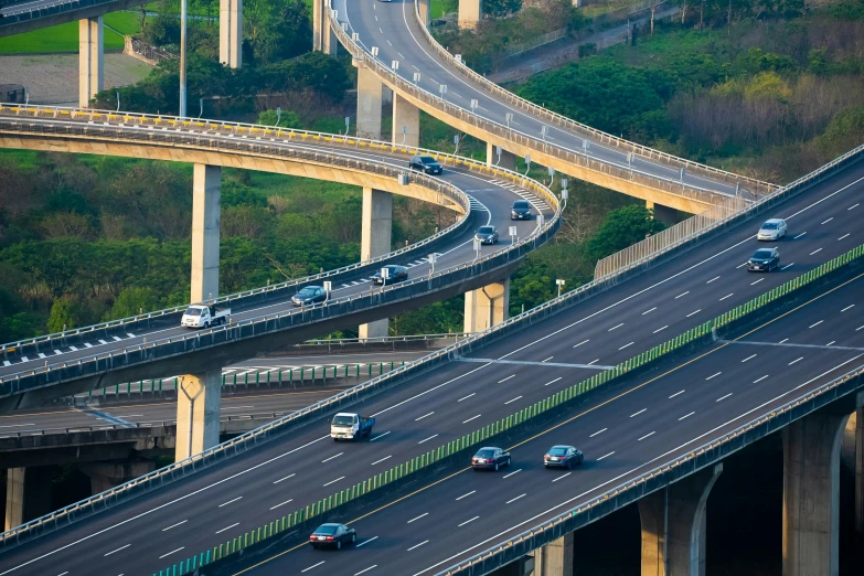 two rows of cars drive down an overpass