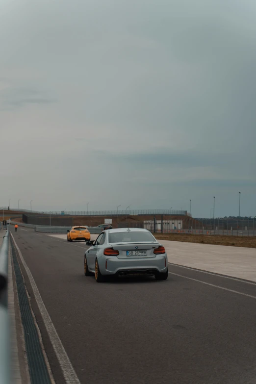 two cars on an empty highway during the day