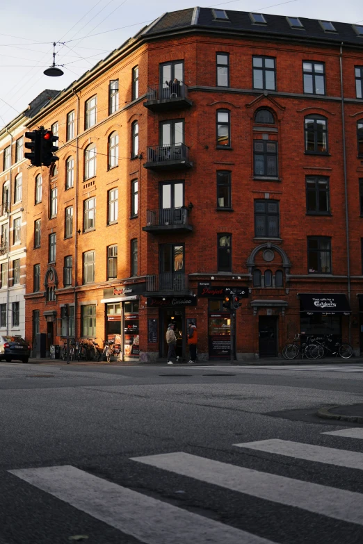 red brick building on street corner with traffic signal in foreground