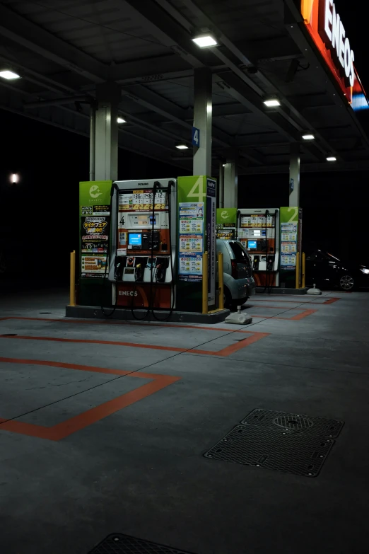 a gas station in the dark with a lot of gas pumps