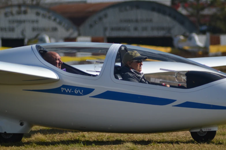 a small airplane that is being watched by a man