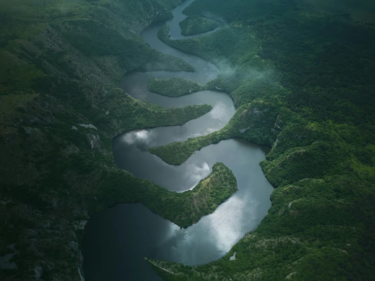 an aerial view of a river and mountains