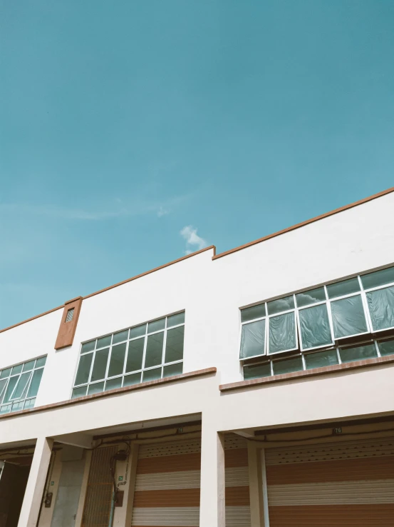 two garages on an empty street under a blue sky