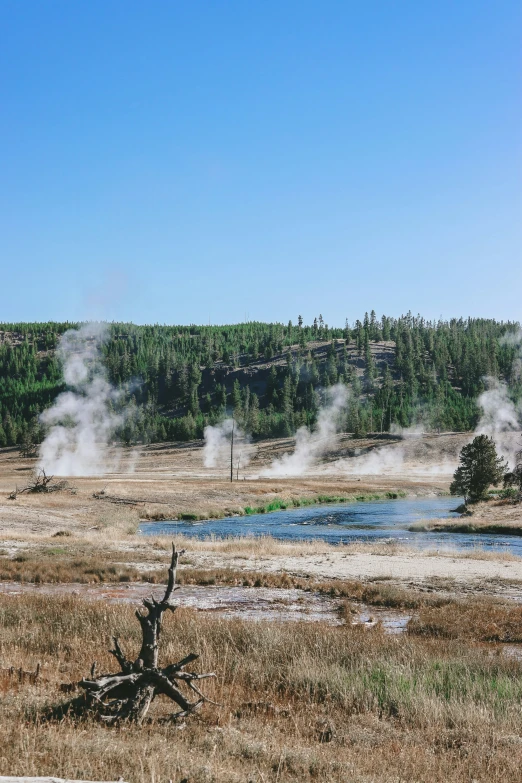 steam rising from the ground near a dry field