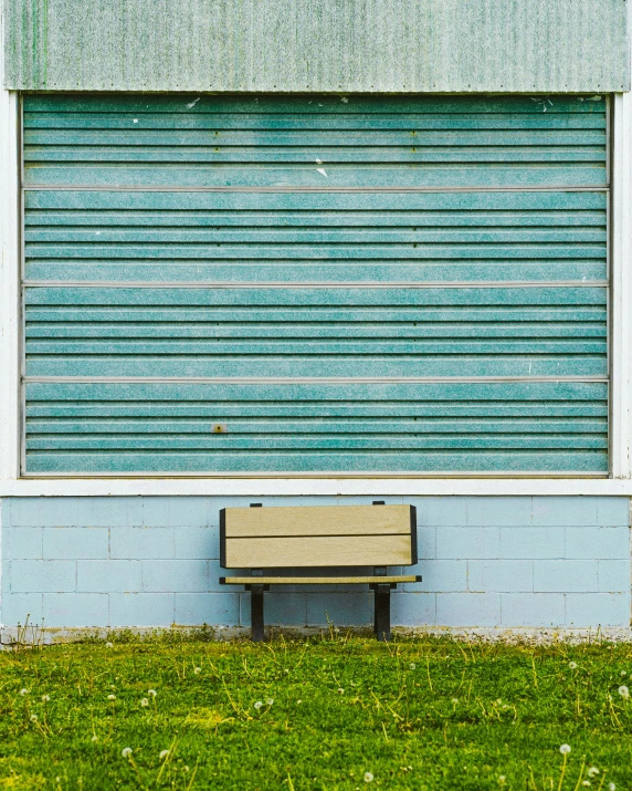 a small bench next to a closed garage door