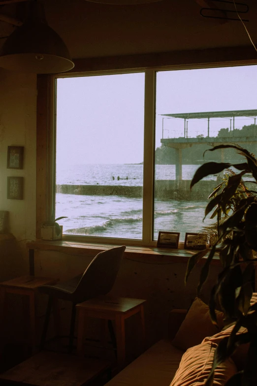 the interior of a house with furniture, a chair, and open window