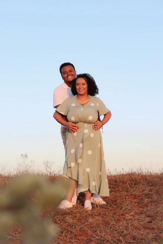 a man and a woman smile together in a field