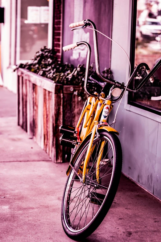 yellow bike parked next to a building with the door open