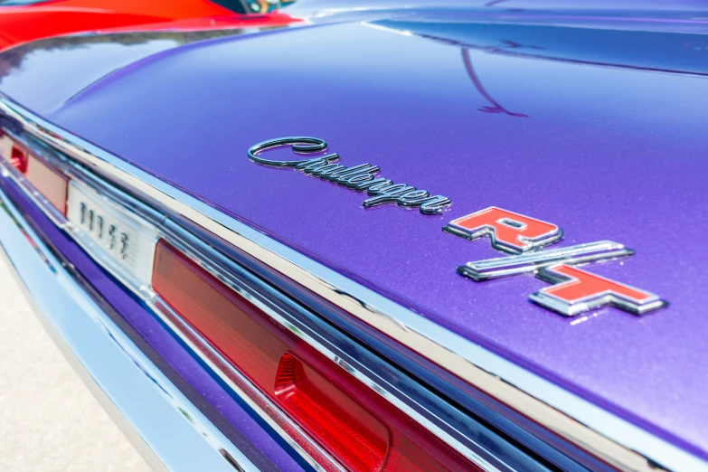 some classic cars that have been painted very bright purple